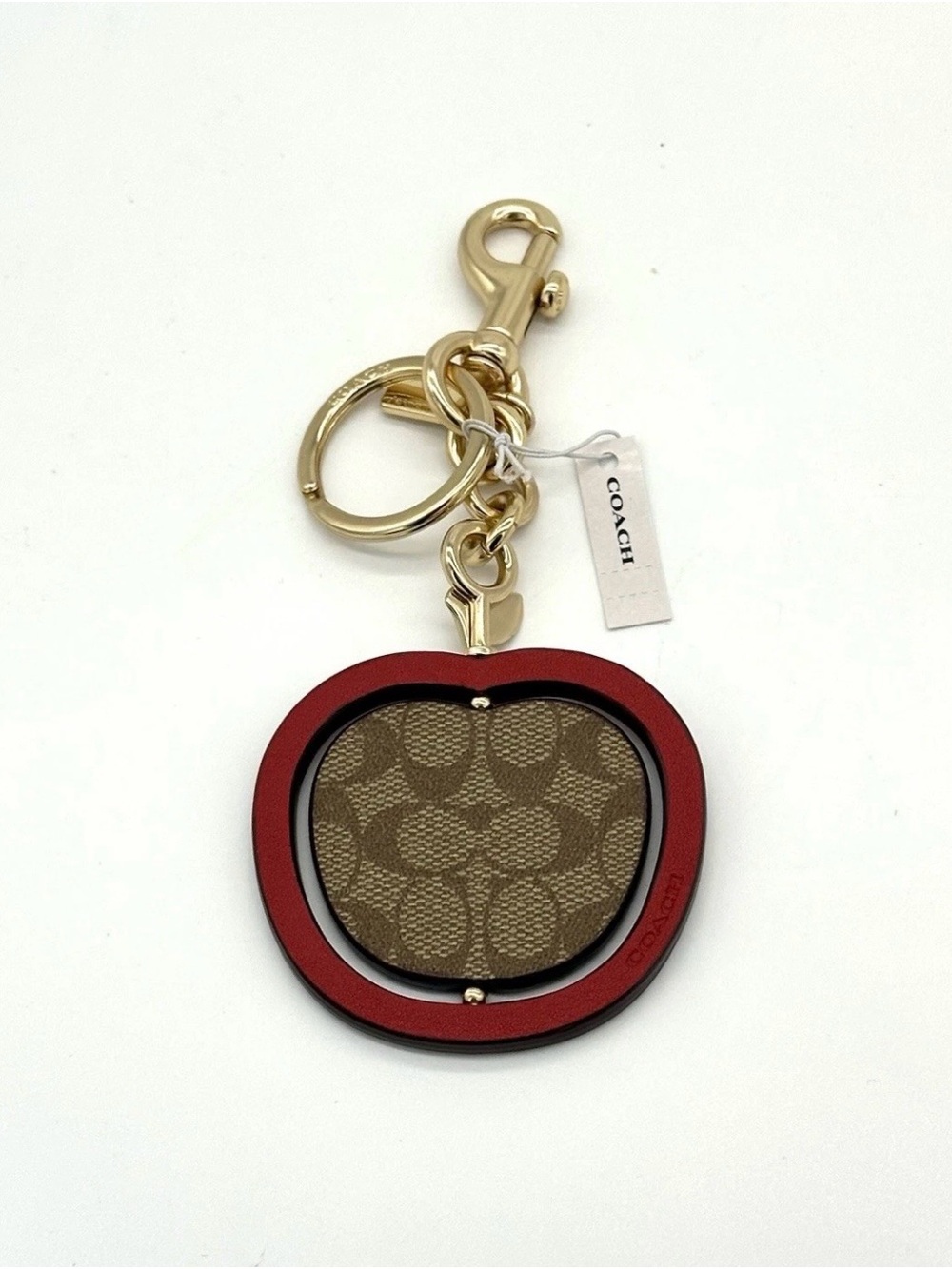 Coach Spinning Apple Bag Charm In Signature Canvas Saddle/ Dark Brown
